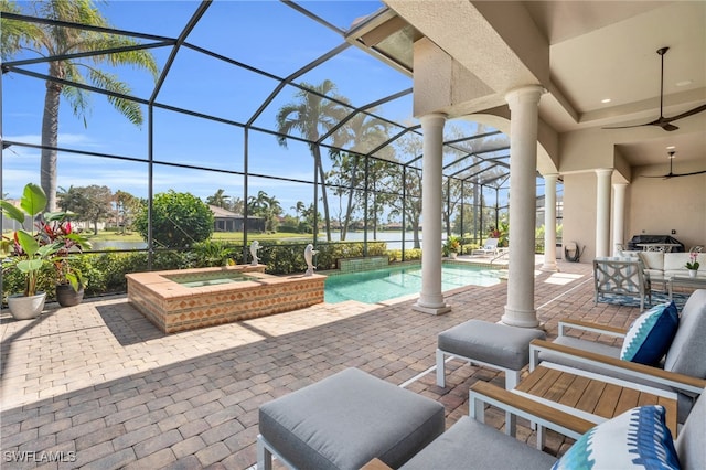 view of patio with a swimming pool with hot tub, glass enclosure, and ceiling fan