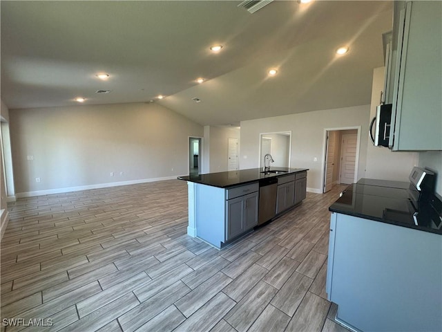 2919 NW 10th St, Cape Coral, FL 33993 - kitchen featuring appliances with stainless steel finishes, a sink, dark countertops, lofted ceiling, and wood finish floors