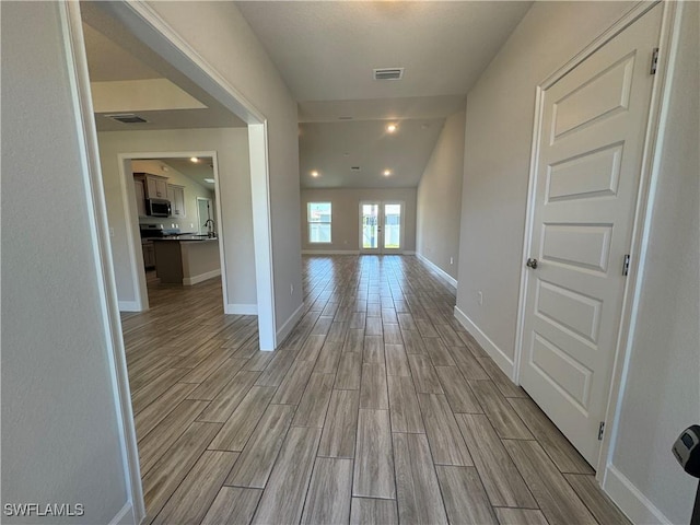 2919 NW 10th St, Cape Coral, FL 33993 - corridor featuring light wood finished floors and baseboards