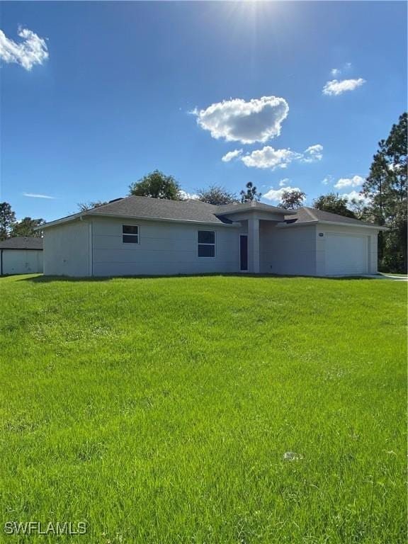 exterior space with a garage and a front lawn