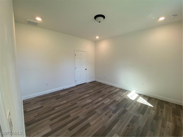 unfurnished room with dark hardwood / wood-style floors