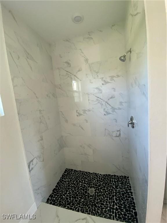 bathroom with a tile shower