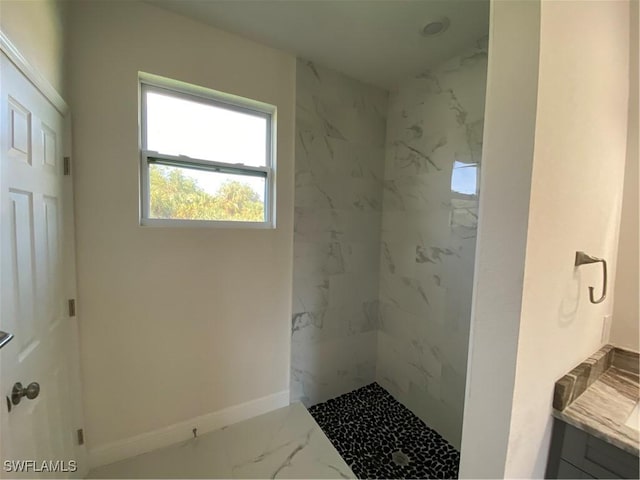 bathroom with vanity and tiled shower