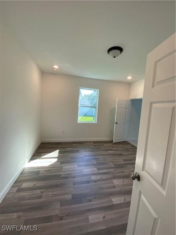 unfurnished room featuring dark hardwood / wood-style floors