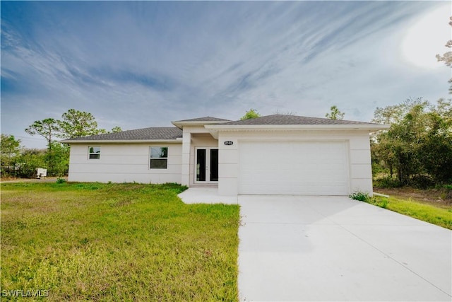 view of front of property with a front yard and a garage