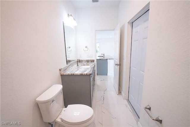 bathroom featuring toilet and vanity