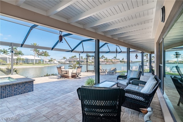 view of patio / terrace with glass enclosure, a water view, an outdoor hangout area, and an in ground hot tub