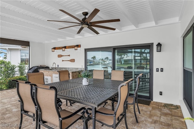 view of patio with ceiling fan, area for grilling, and an outdoor wet bar