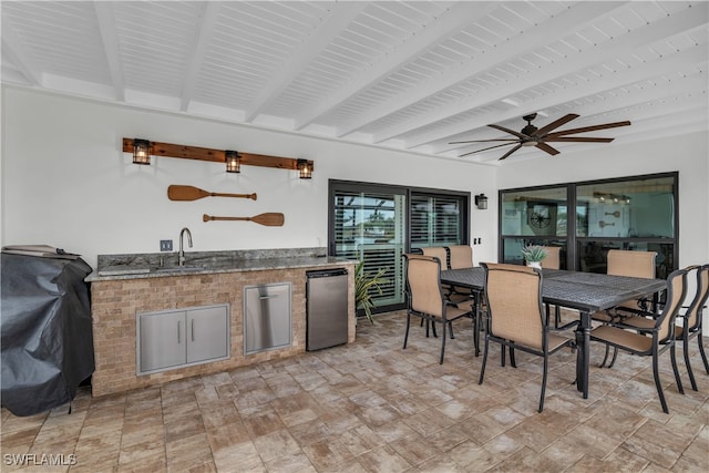 interior space featuring ceiling fan, beam ceiling, and wet bar