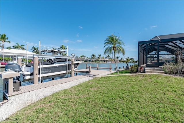 view of dock featuring a water view, glass enclosure, and a lawn