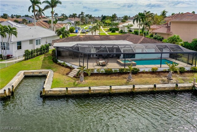 exterior space with a lanai, a patio area, a water view, and a boat dock