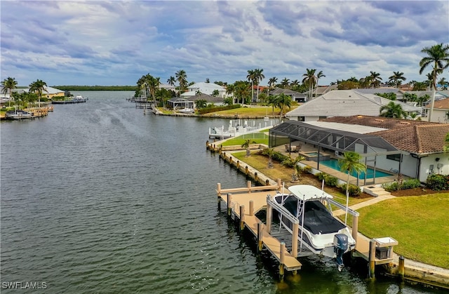 dock area with a lawn and a water view