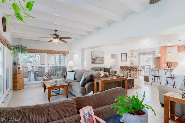 living room featuring ceiling fan, light tile patterned floors, and a healthy amount of sunlight