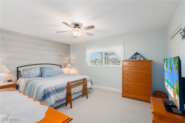 bedroom with ceiling fan and light colored carpet