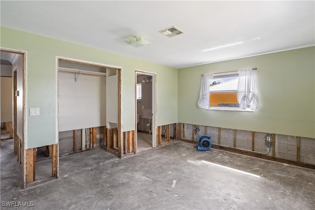 unfurnished bedroom featuring a closet and ensuite bath