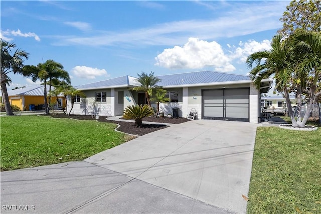 ranch-style house featuring a garage and a front lawn