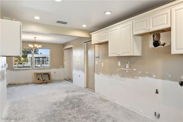 kitchen with white cabinetry and a notable chandelier