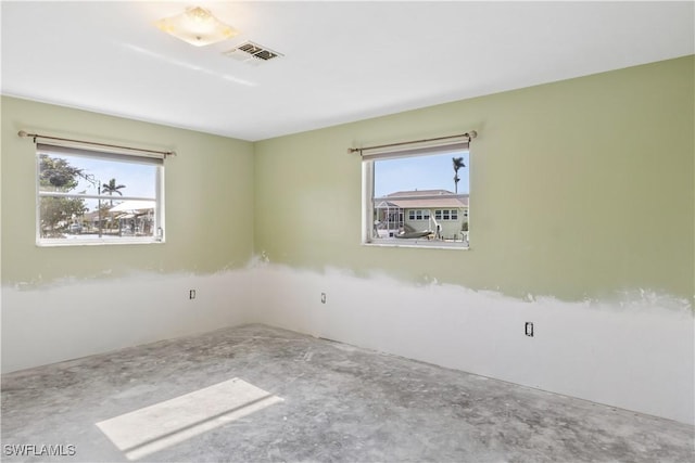 unfurnished room featuring concrete flooring