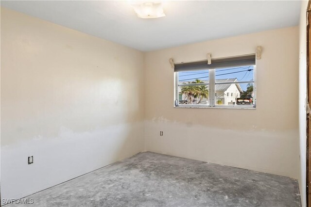 spare room with concrete floors