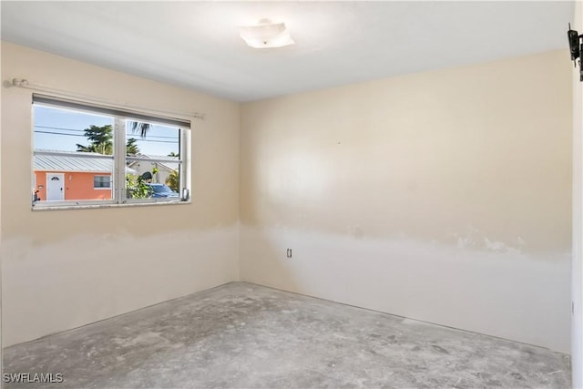 spare room featuring concrete flooring