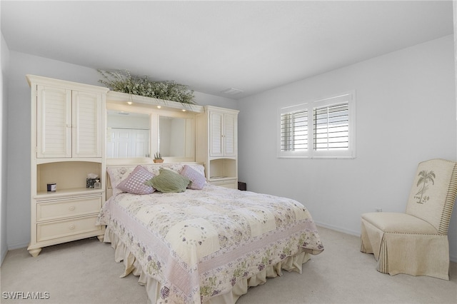 bedroom featuring light colored carpet