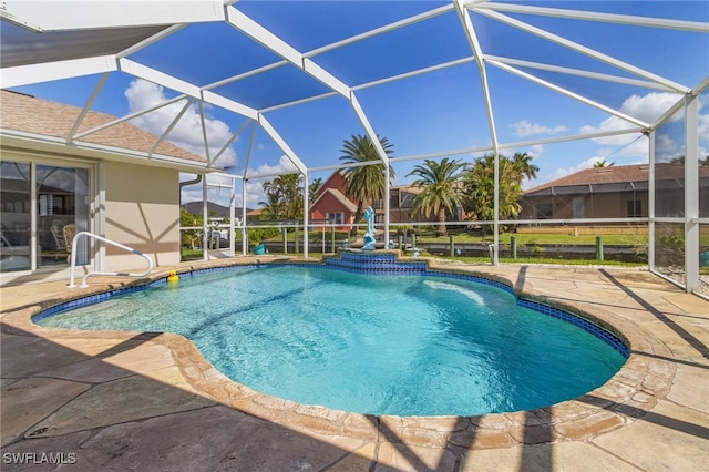 view of pool featuring a patio and glass enclosure