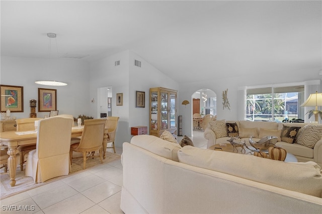 tiled living room with high vaulted ceiling