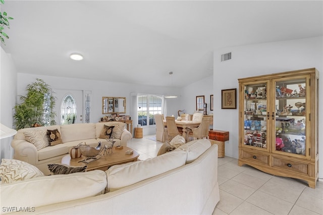 tiled living room featuring lofted ceiling