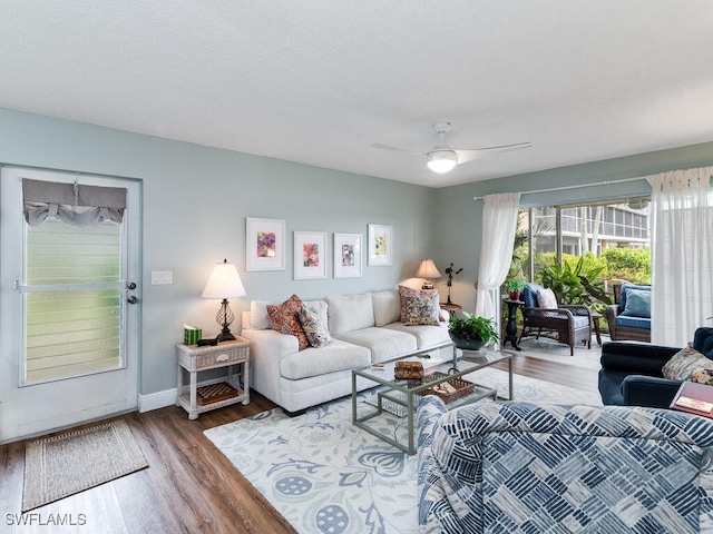 living room featuring hardwood / wood-style floors and ceiling fan