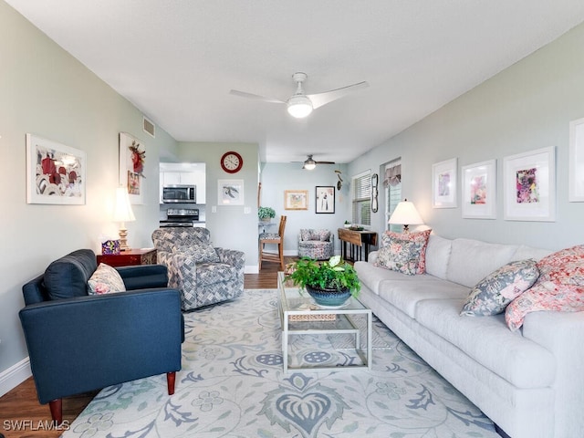 living room with ceiling fan and light wood-type flooring