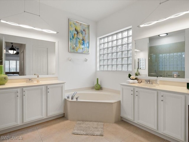 bathroom with tile patterned floors, separate shower and tub, and vanity