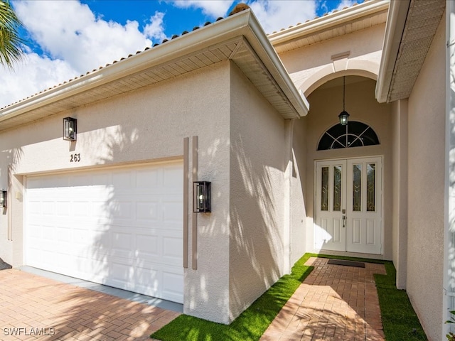 view of exterior entry with a garage