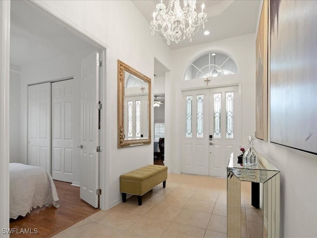 foyer featuring a notable chandelier and light tile patterned flooring