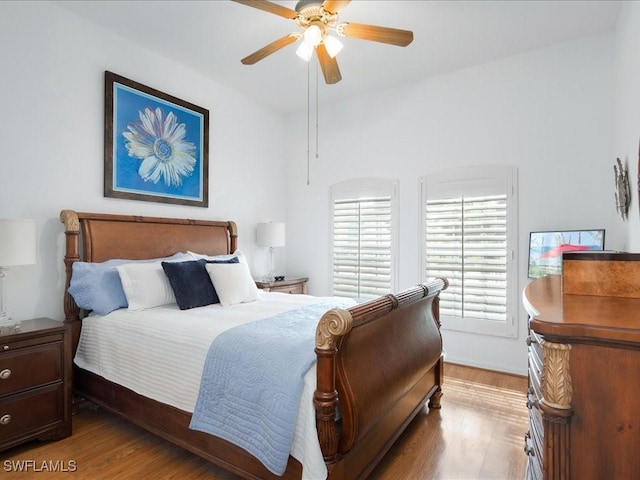 bedroom with light hardwood / wood-style flooring and ceiling fan