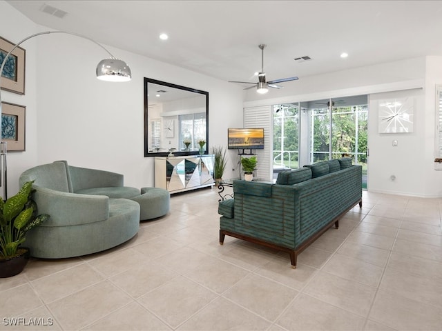 tiled living room with ceiling fan