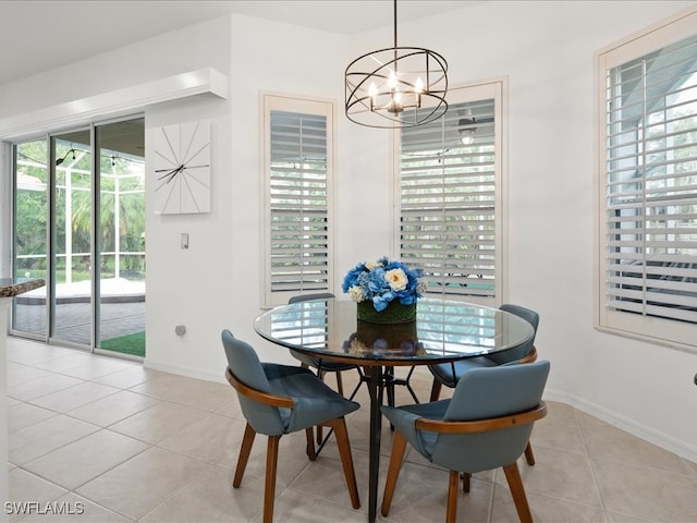 dining area with light tile patterned floors and a notable chandelier