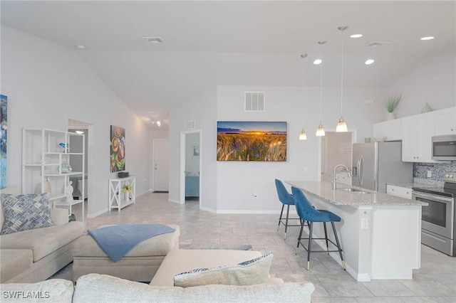 living room featuring sink and vaulted ceiling