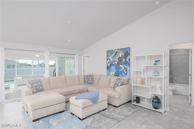 living room featuring lofted ceiling and light tile patterned floors