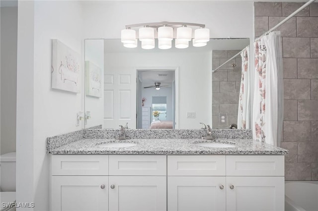 full bathroom with vanity, toilet, ceiling fan, and shower / tub combo with curtain