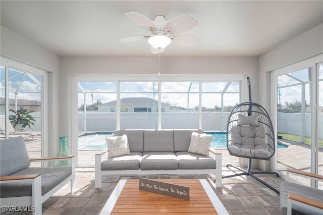 sunroom with plenty of natural light and ceiling fan