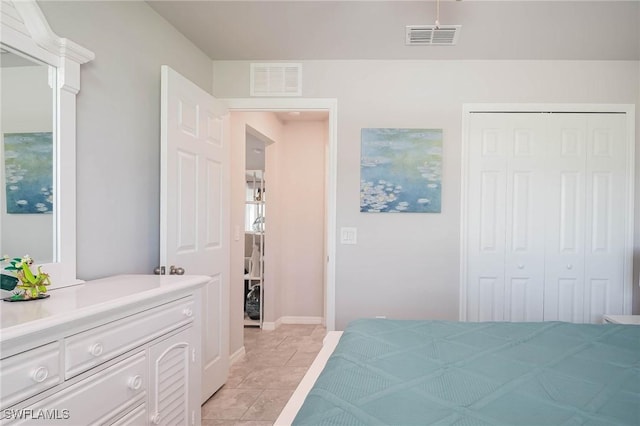 bedroom featuring light tile patterned floors and a closet