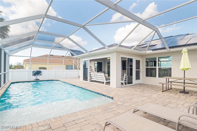 view of swimming pool with glass enclosure and a patio area