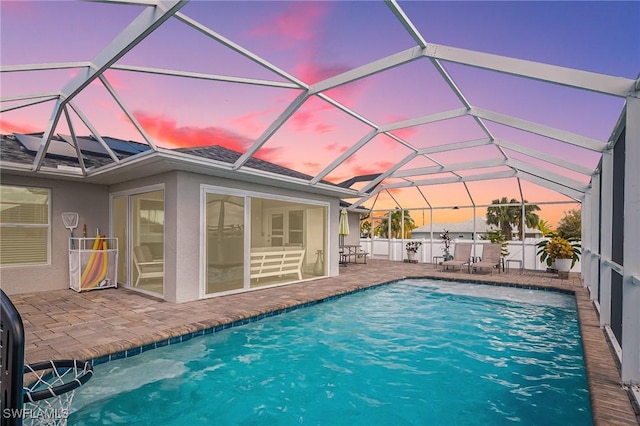 view of swimming pool featuring a lanai, a patio area, fence, and a fenced in pool