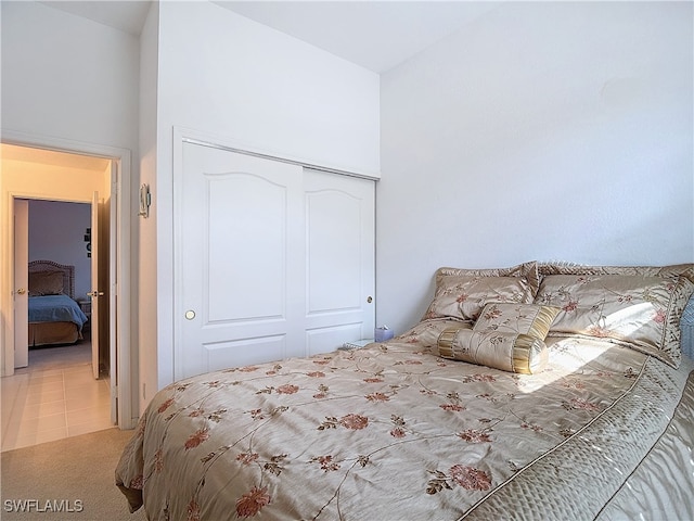 carpeted bedroom with a closet