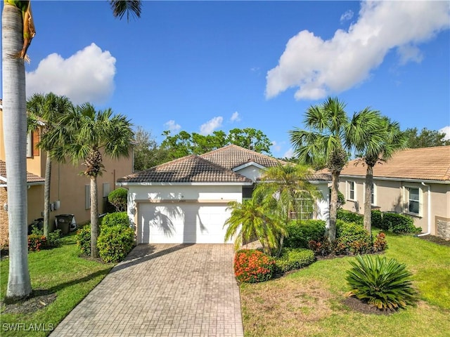 2505 Keystone Lake Dr, Cape Coral, FL 33909 - view of front of house featuring a garage, stucco siding, a front yard, decorative driveway, and a tiled roof