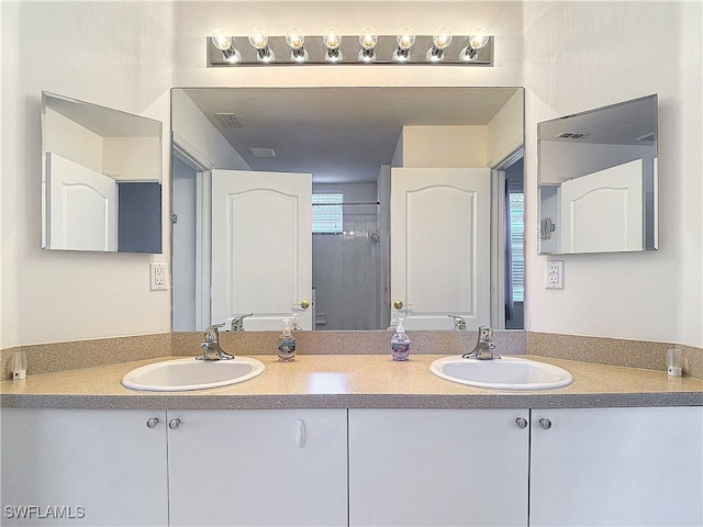 bathroom featuring vanity and a shower