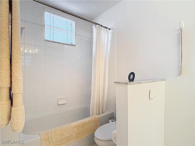 bathroom with shower / bath combination with curtain and toilet