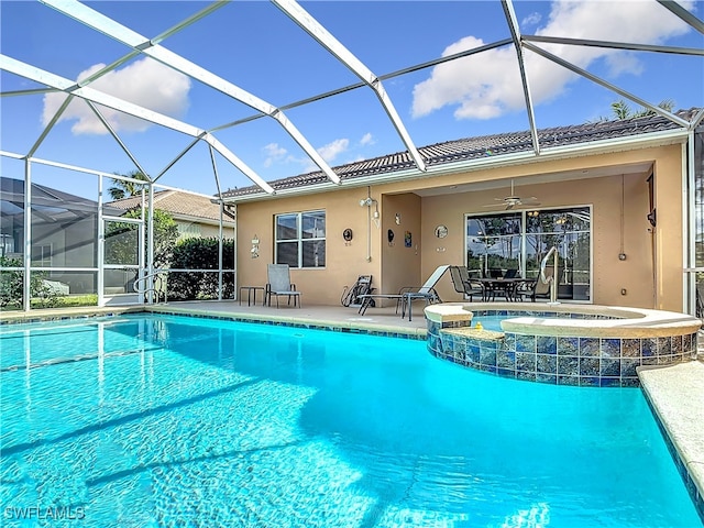 view of swimming pool with a patio, ceiling fan, an in ground hot tub, and glass enclosure