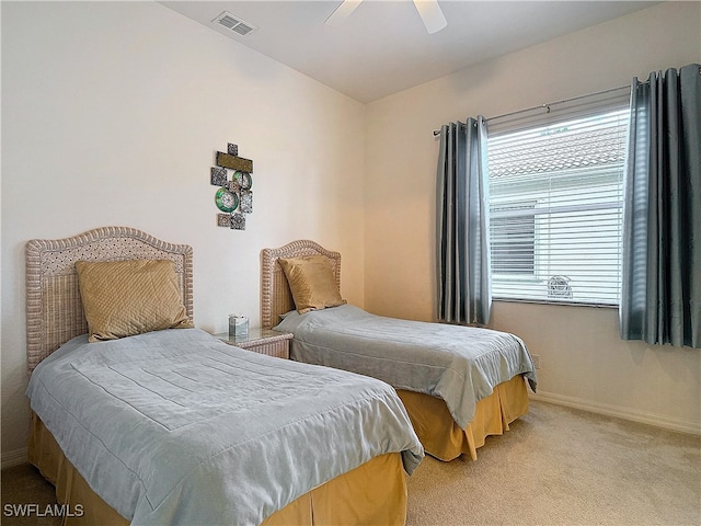 bedroom featuring light carpet and ceiling fan