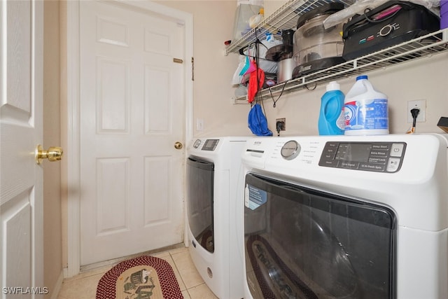 laundry room featuring washer and dryer and light tile patterned floors